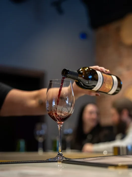 Red wine being poured at the Tesoro bar